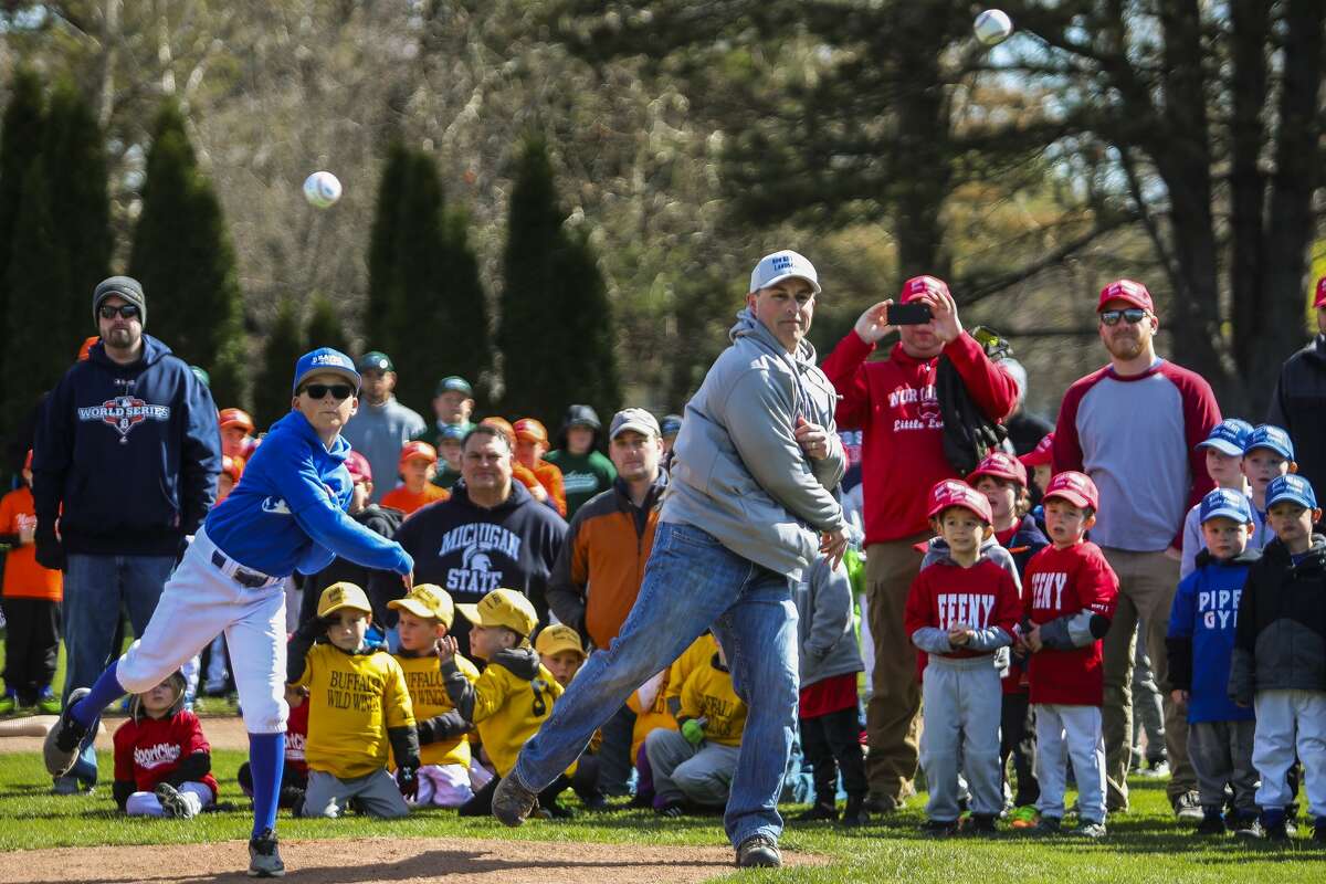 Zane Hemler, left, and Matt Hansen, right, throw out the first pitches of the season during Northeast Little League's opening day ceremony on Saturday, April 27, 2019 at Plymouth Park. (Katy Kildee/kkildee@mdn.net)