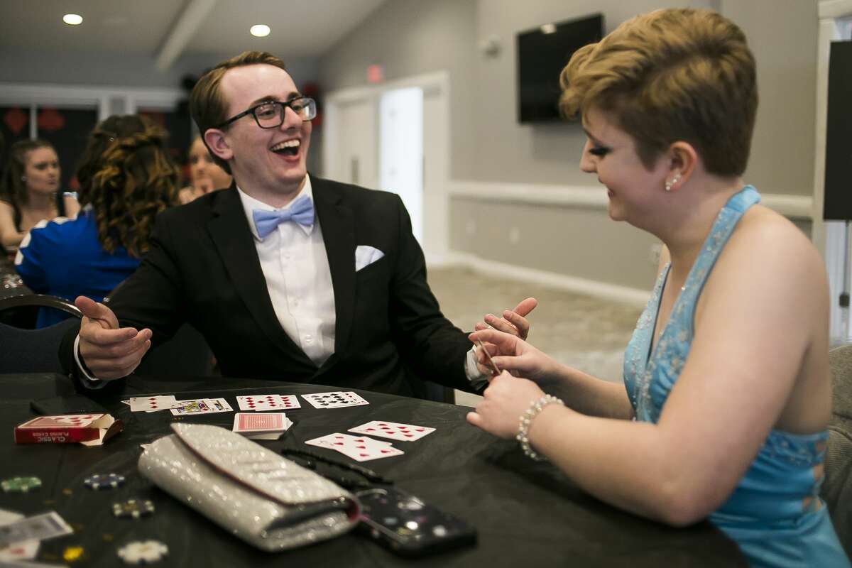 Coleman High School senior Angelie Balliet, right, plays Go Fish with her guest, Weston Smith, left, during Coleman's prom at PohlCat Golf Course in Mount Pleasant on Saturday, April 27, 2019. (Katy Kildee/kkildee@mdn.net)