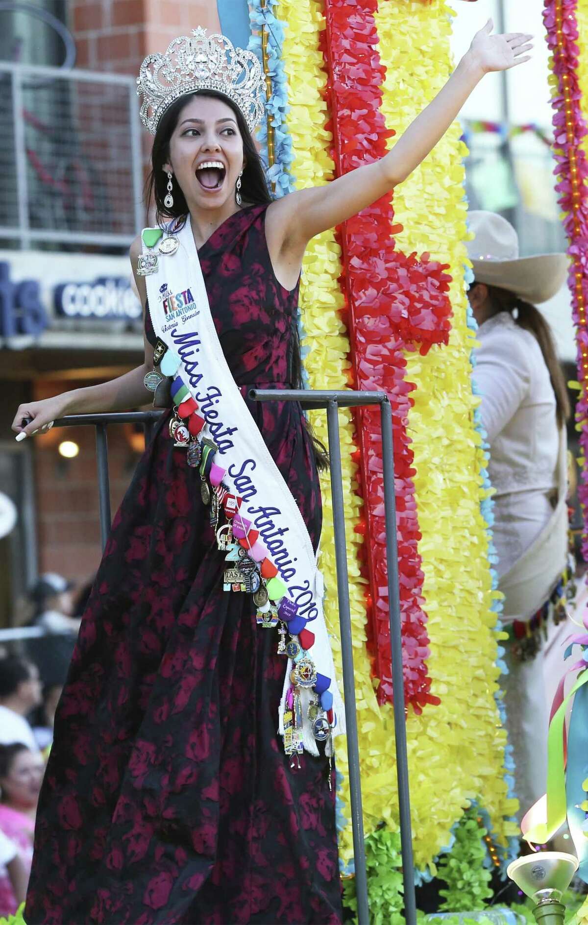 Miss Fiesta responds to cheers during the Fiesta Flambeau Parade on April 27, 2019.