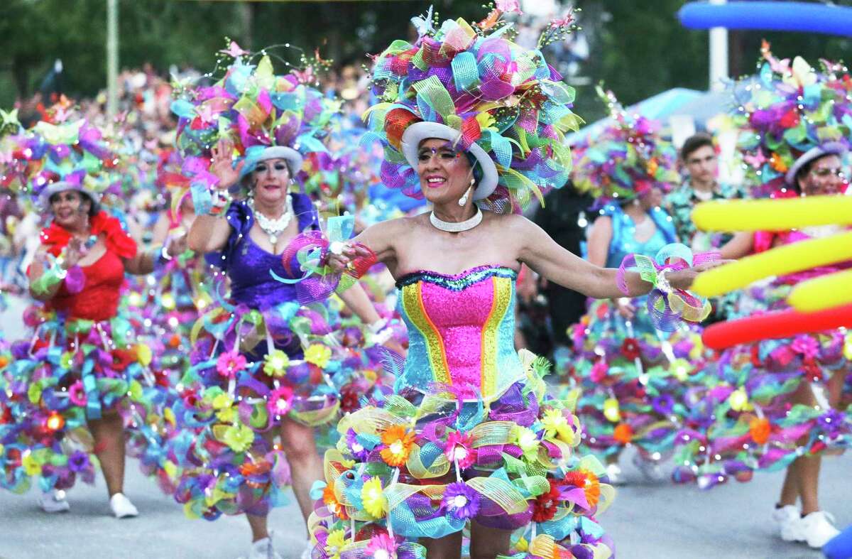 Las Charangas dancers move down Broadway in the Fiesta Flambeau Parade last year.