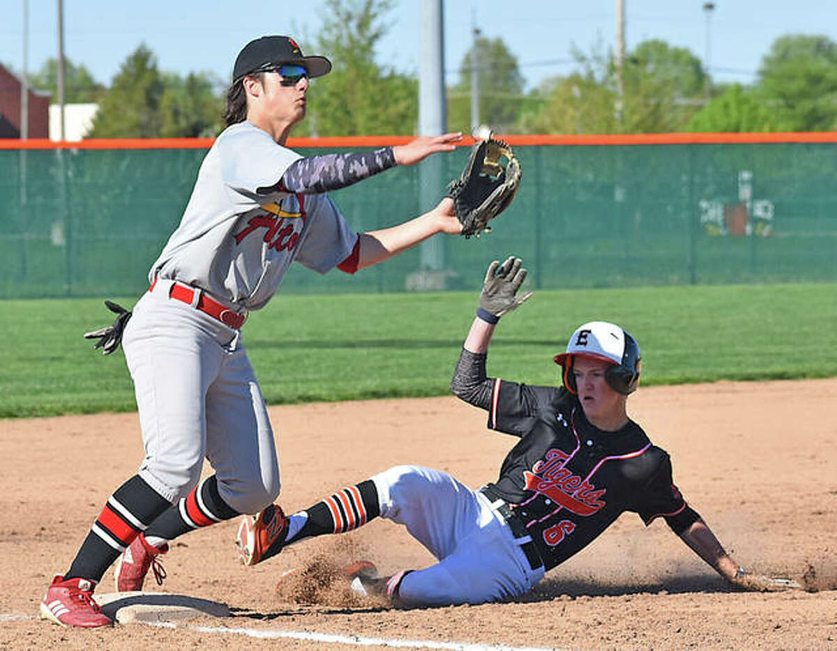 Edwardsville’s Hayden Moore slides under the tag of the Alton third baseman on Friday afternoon at Tom Pile Field. The Tigers also played Friday night against Civic Memorial.