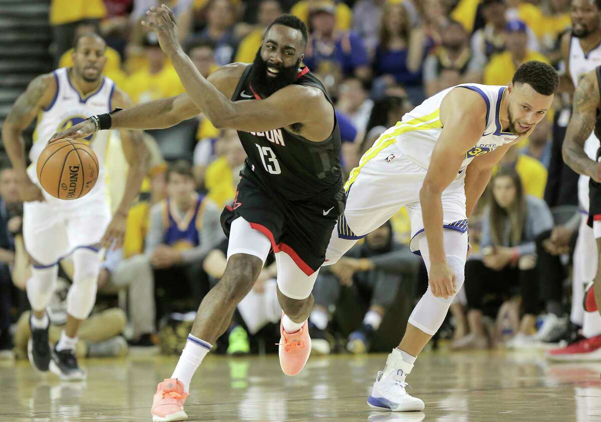 Houston Rockets guard James Harden (13) bumps into Golden State Warriors guard Stephen Curry (30) after chasing down a loose ball in the first half of Game 1 of the NBA playoffs at the Oracle Arena on Sunday, April 28, 2019 in Oakland.