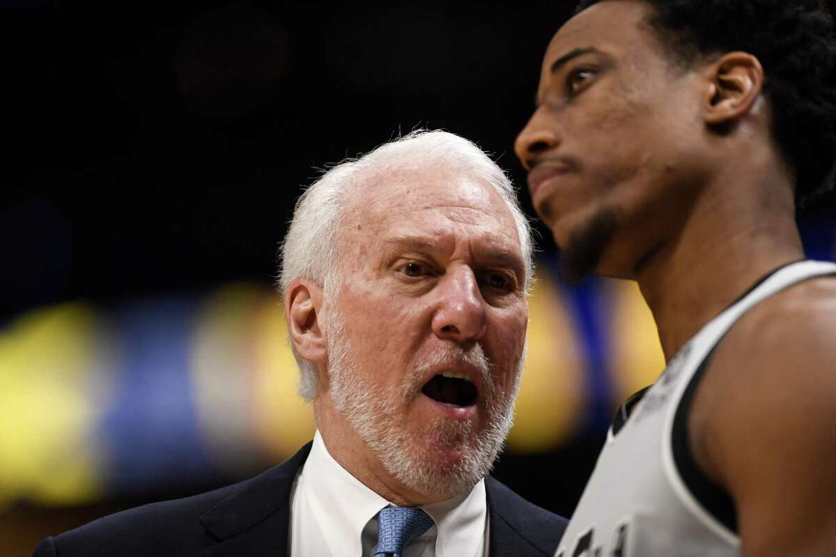 Spurs coach Gregg Popovich counsels DeMar DeRozan during the third quarter of Game 7 against the Denver Nuggets on Saturday night. Pop’s contract expired when the Spurs’ season ended.