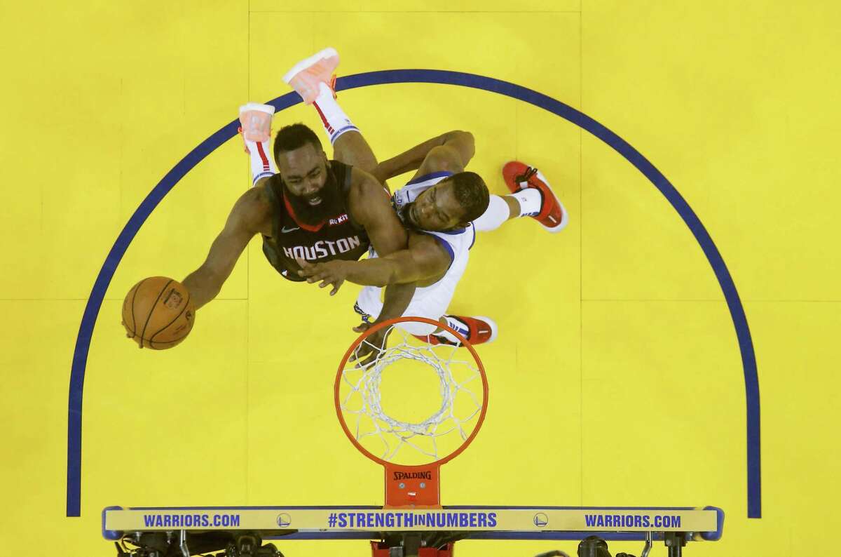 Houston Rockets guard James Harden (13) puts up the ball around Golden State Warriors forward Kevin Durant (35) during Game 1 of the NBA playoffs at the Oracle Arena on Sunday, April 28, 2019 in Oakland. Golden State Warriors won the game 104-100.