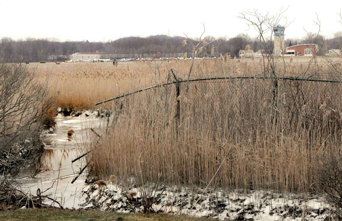 A fence around Tweed-New Haven airport stops near a stream adjacent to Dean Street and Morris Causeway in New Haven in 2013.