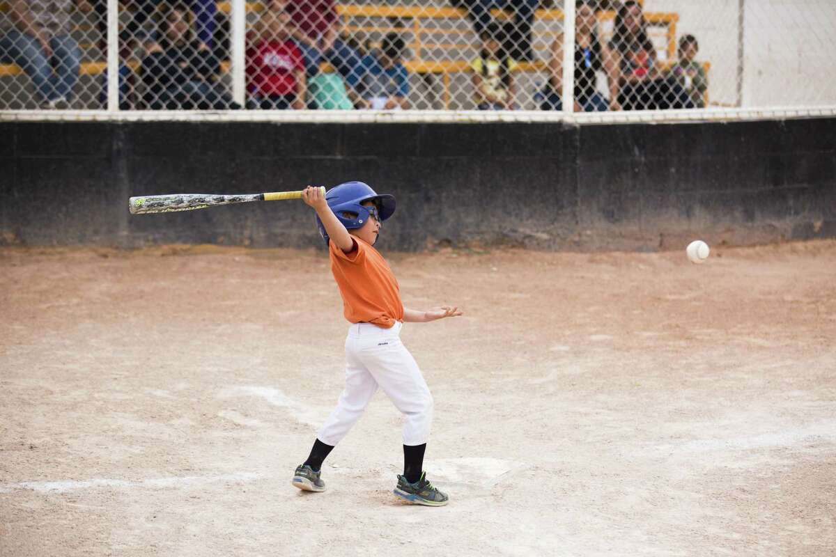 Guillermo “Memo” Garcia, 6, hits the ball during a game on April 5 in Ciudad Juárez. Garcia is an American citizen like most in his family, but they divide their activities between El Paso and Ciudad Juárez, where some relatives live.