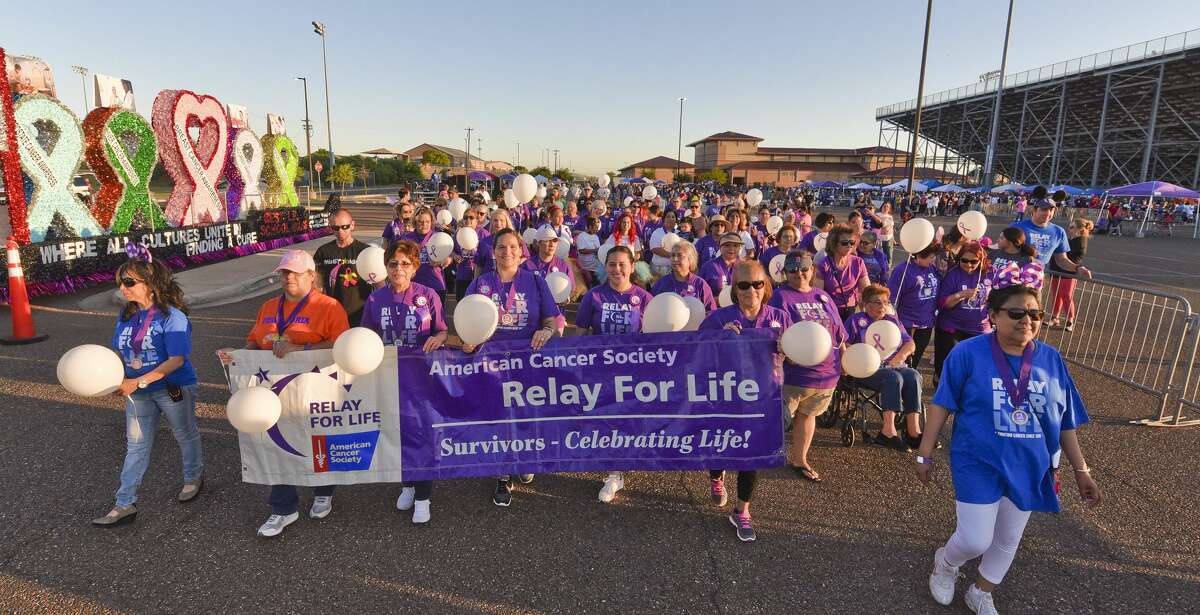The crowd shows support for cancer survivors as they take the first lap in the Webb County Relay for Life Friday, Apr. 26, 2019, at the U.I.S.D. Student Activity Complex.