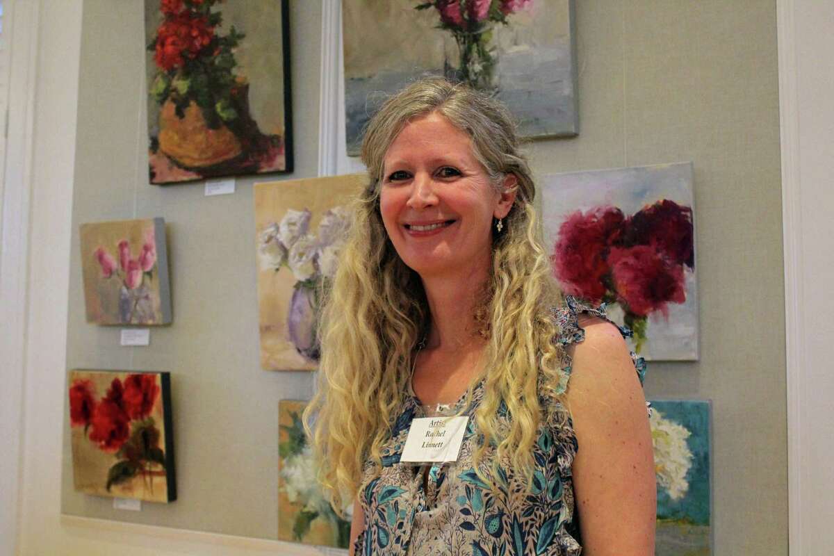 Artist Rachel Linnett in front of her collection of paintings for sale at the Westport Woman's Club's annual art show on April 27, 2019.
