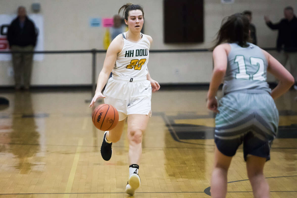 Dow High's Maizie Taylor brings the ball upcourt during a March 13, 2019 regional final vs. Saginaw Heritage.