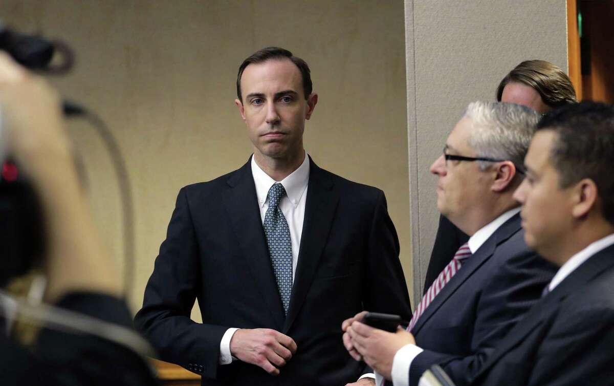 Secretary of State David Whitley, left, arrives Feb. 7 for his confirmation hearing in Austin, Texas. He resigned Monday after the Senate refused to take a vote on his nomination. He is back on Gov. Greg Abbott’s payroll at $205,000 a year.