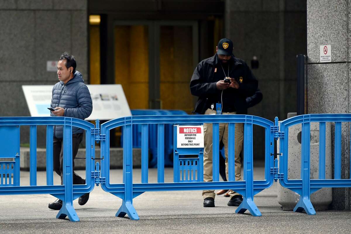 A security guard stands behind a barricade outside of PG&E's headquarters in San Francisco, CA, on Monday January 14, 2019.