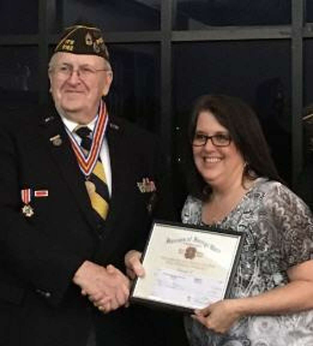 Katy Veterans of Foreign Wars Post 9182 Commander Don Byrne congratulates Teri Gardner, a third-grade teacher at Exley Elementary, who received the Citizenship Education Teacher of the Year award on March 30.