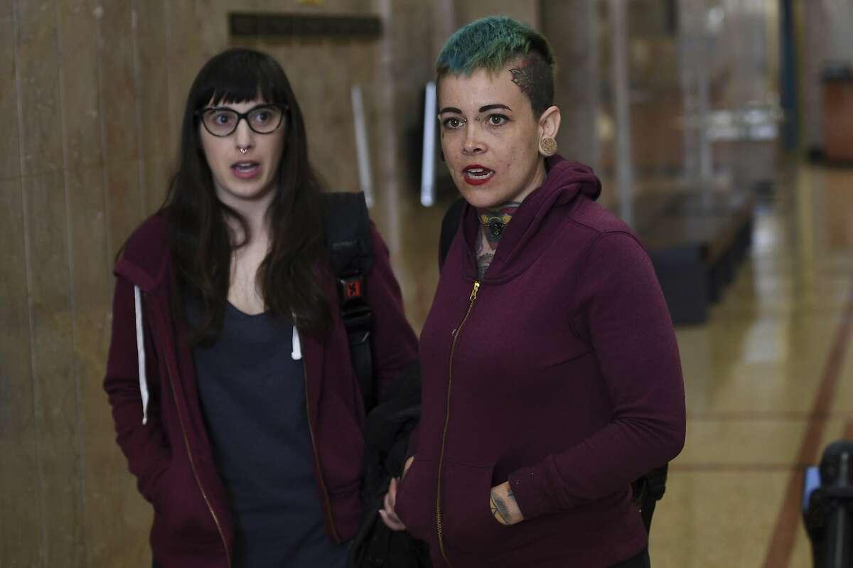 Danielle Silva, right, of Oakland, Calif., and Marie Angel, of Albany, Calif., who identified themselves as Max Harris supporters, speak to the media at the Alameda County Courthouse in Oakland, Calif., Tuesday April, 30, 2019. Two defendants, Derick Almena and Max Harris are standing trial on charges of involuntary manslaughter after a 2016 fire killed 36 people at a warehouse party they hosted in Oakland. (AP Photo/Cody Glenn)