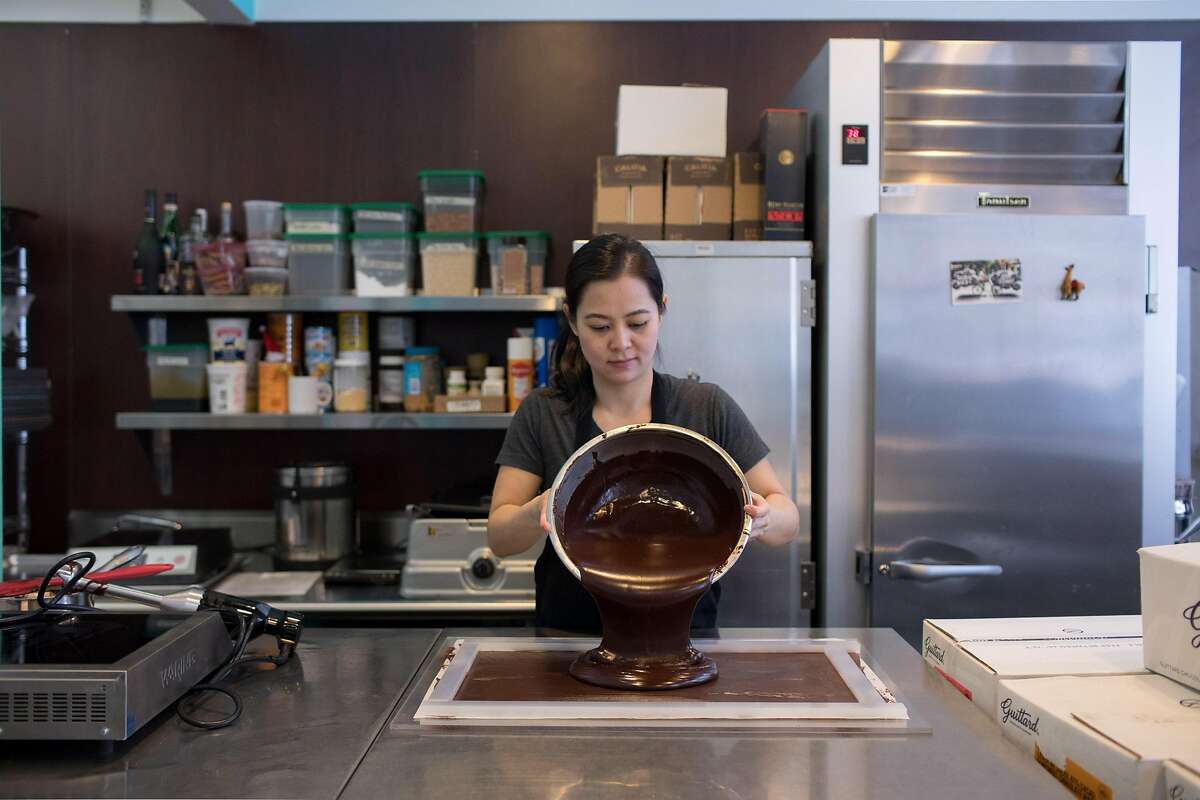 Chef and owner Wendy Lieu pours the chocolate and caramel mixture into a mold for cooling before using a confectionary guitar cutter to cut the pieces uniformly at S�c�la Chocolatier in San Francisco, Calif. on Thursday, February 28, 2019.