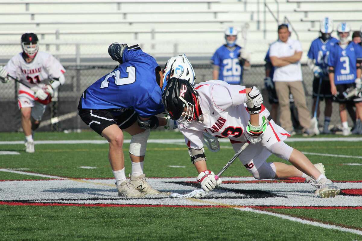 New Canaan’s Justin Wietfeldt, right and Ludlowe’s Evan Rose battle for a faceoff during a game last season at New Canaan High School.