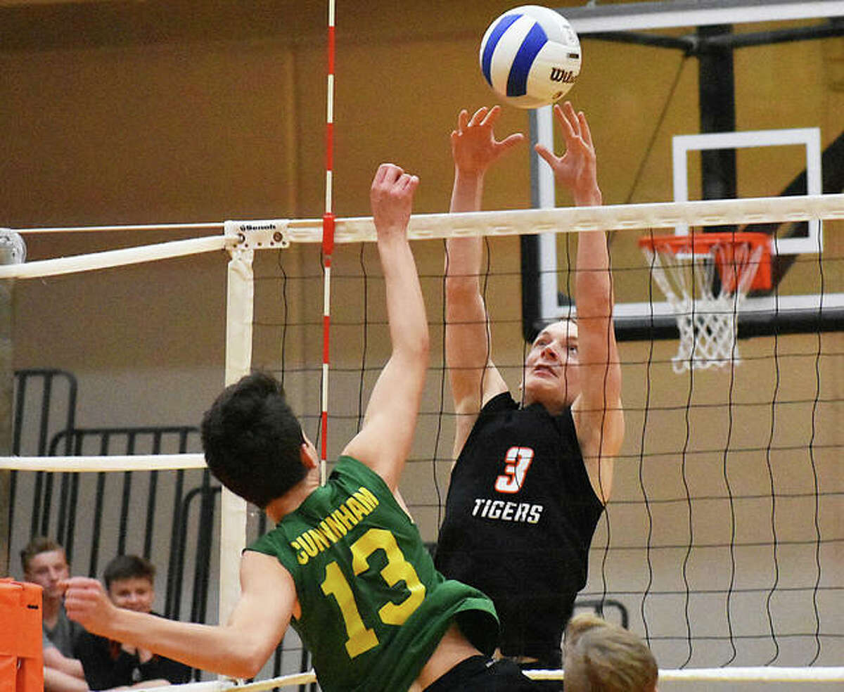 Edwardsville’s Brock Hening gets a block against MELHS in the first game.