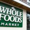 A Whole Foods Market sign is seen in Washington, DC, June 16, 2017, following the announcement that Amazon would purchase the supermarket chain for $13.7 billion. Amazon is once again shaking up the retail sector, with the announcement it will acquire upscale US grocer Whole Foods Market, known for its pricey organic options, in a deal that underscores the online giant's growing influence in the economy. / AFP PHOTO / SAUL LOEB (Photo credit should read SAUL LOEB/AFP/Getty Images)
