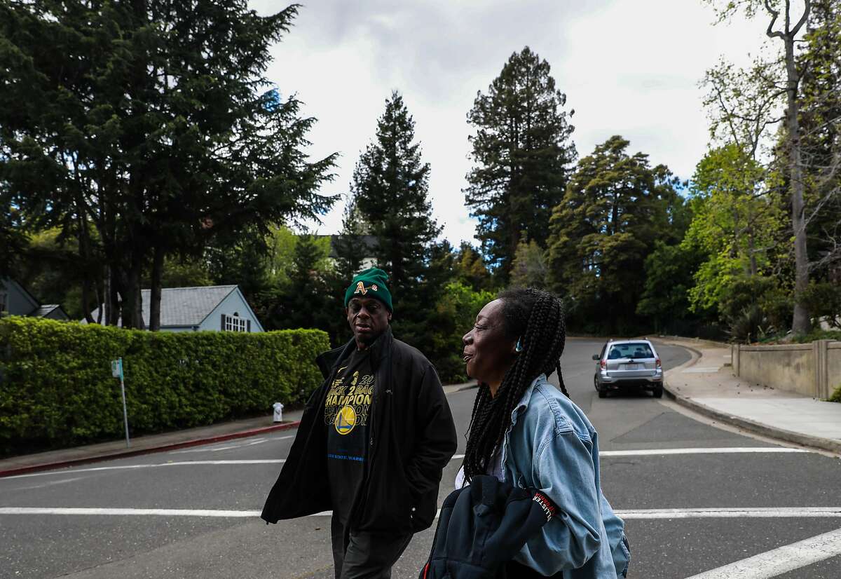 Greg Dunston, Sr., 61, and his partner Marie Mckinzie, 53, walk back home after visiting Hampton Park, in Piedmont, Calif., on Tuesday, April 16, 2019. Greg and Marie moved into a basement apartment in Piedmont after living on the streets of Oakland on and off for ten years.