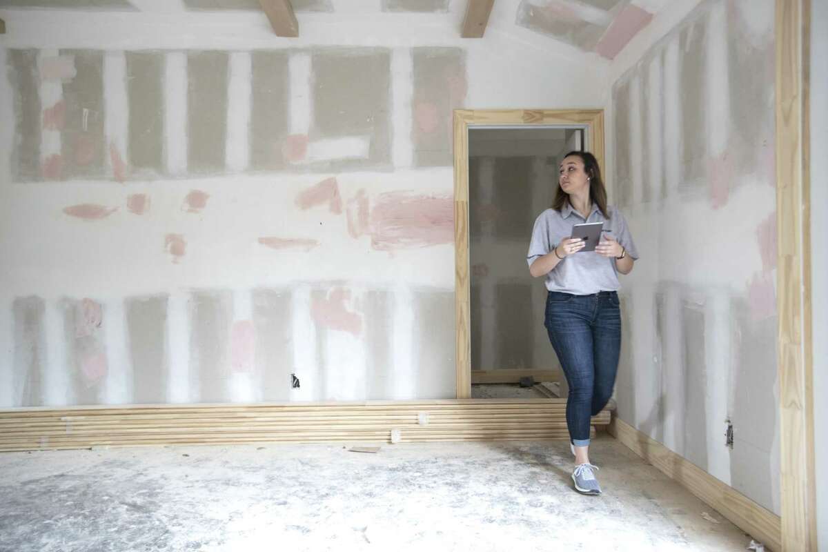 Bailee Wright, transaction coordinator for Entera, inspects and takes photos of progress on a home remodel for an institutional investor on Friday, March 8, 2019, in Houston.