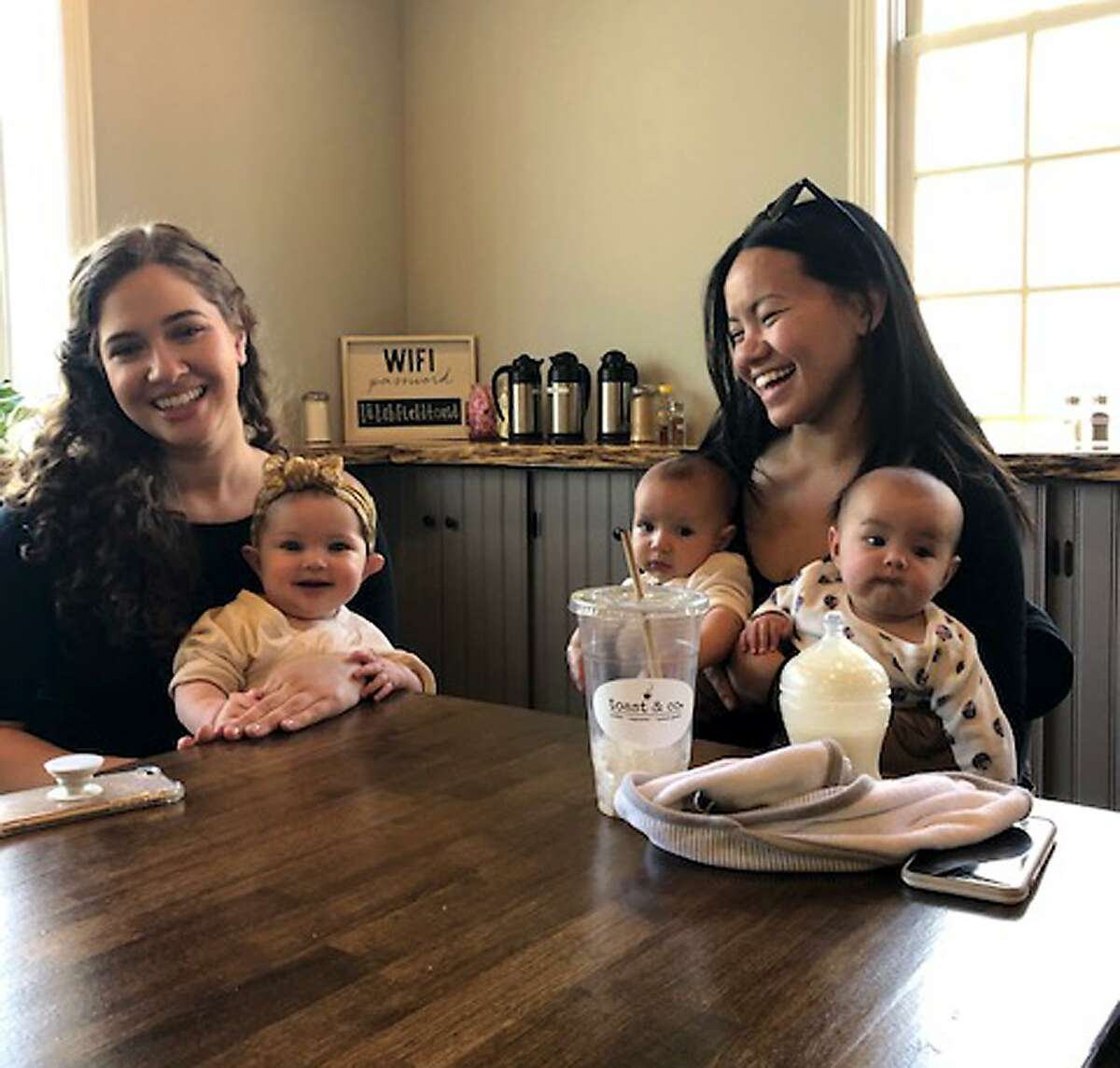 Miranda Gordon of Litchfield with baby Isla, left, and Razina Rintharme of Litchfield with twins Ryan Jr. and Leila enjoy the fare at Toast & Co.