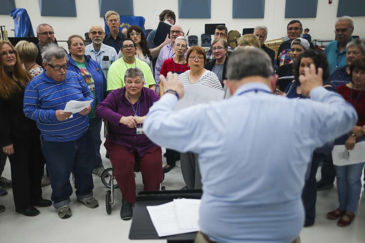 Jim Hohmeyer, right, directs a group of singers from area churches and choirs on Sunday, April 7, 2019 at Midland High School during a rehearsal for an upcoming concert called "Brave New Voices." (Katy Kildee/kkildee@mdn.net)