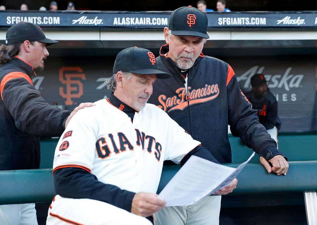 San Francisco Giants' manager Bruce Bochy and bench coach Ron Wotus strategize before 3-2 win over Los Angeles Dodgers during MLB game at Oracle Park in San Francisco, Calif., on Monday, April 29, 2019.