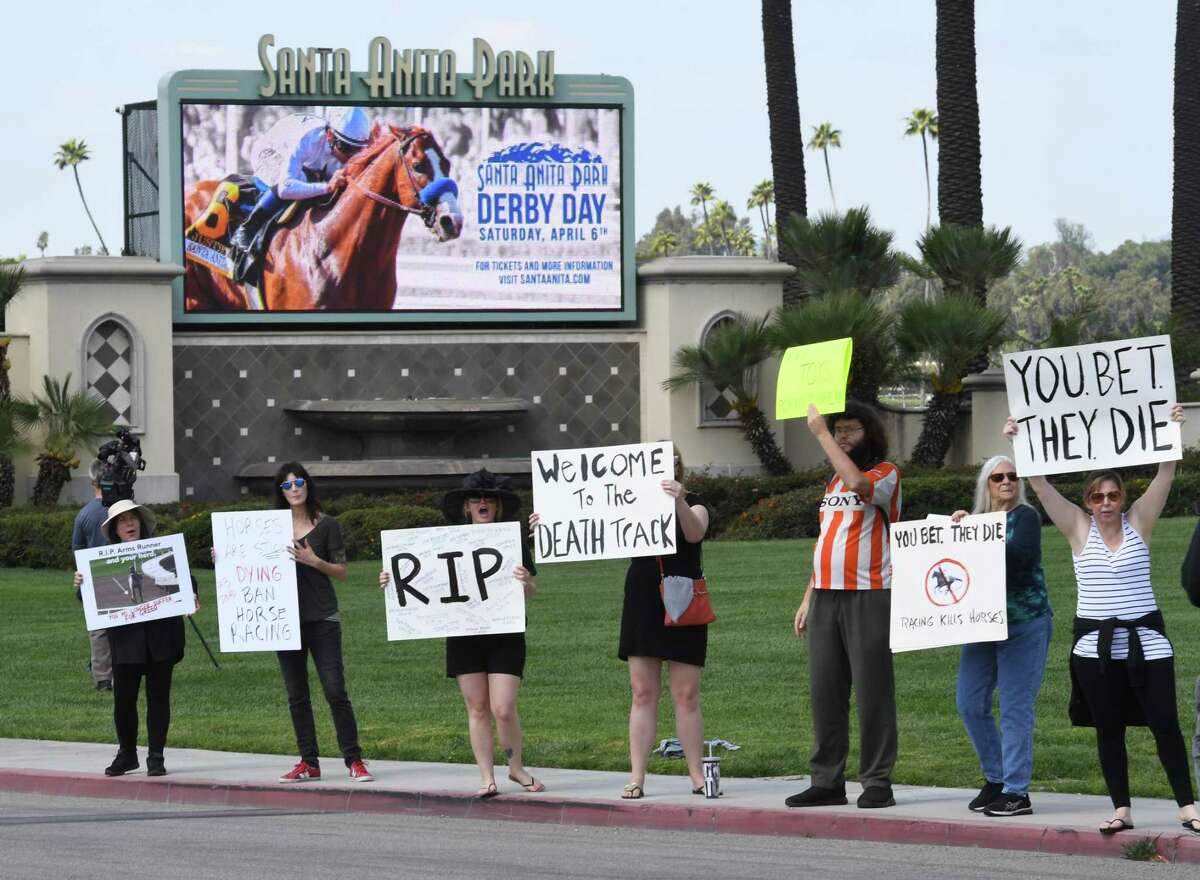 Animal-rights advocates protest beside the entrance gate, the deaths of 23 racehorses in the first three months of this year at the Santa Anita Racetrack in Arcadia,, California, on April 6, 2019. - Santa Anita Park averaged more than 55 horse deaths per year from 2008-18, according to data from the California Horse Racing Board, a total of 553 deaths in all, but this year's major rise in deaths is under investigation. (Photo by Mark RALSTON / AFP)MARK RALSTON/AFP/Getty Images