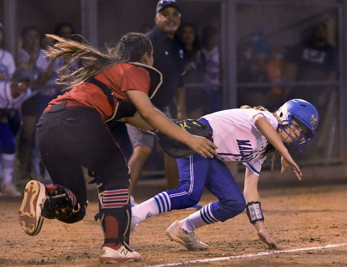 MacArthur's Bryley Westfahl is tagged out by New Braunfels Canyon catcher Kaylyn Cordero during Game 1 of the UIL Class 6A second-round high school softball playoff series on Wednesday May 1, 2019.