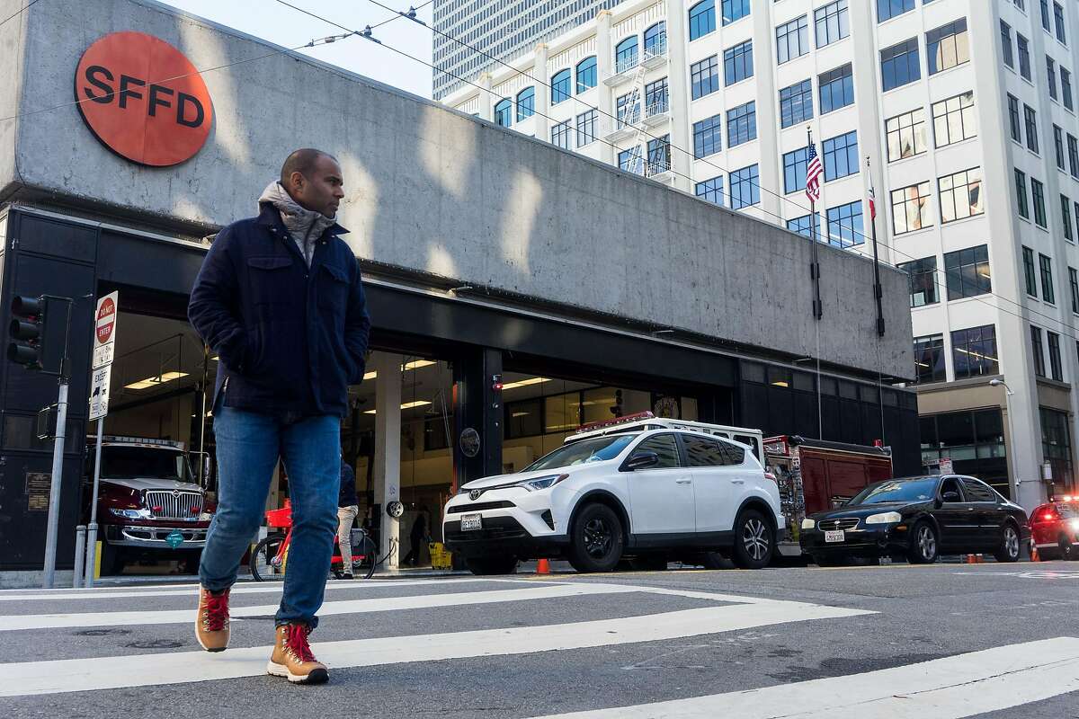A man walks past the fire station at 530 Sansome St. in San Francisco, Calif. on Monday, Jan. 21, 2018. The city is proposing building a fire station and housing at 530 Sansome Street and then use that money from that sale to build affordable housing at 772 Pacific Avenue.
