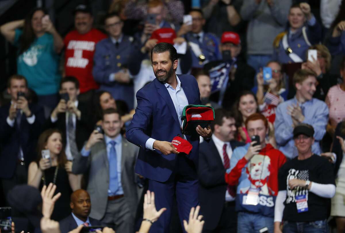 Donald Trump Jr., throws hats to the audience before a rally for President Donald Trump in Grand Rapids, Mich., Thursday, March 28, 2019. (AP Photo/Paul Sancya)