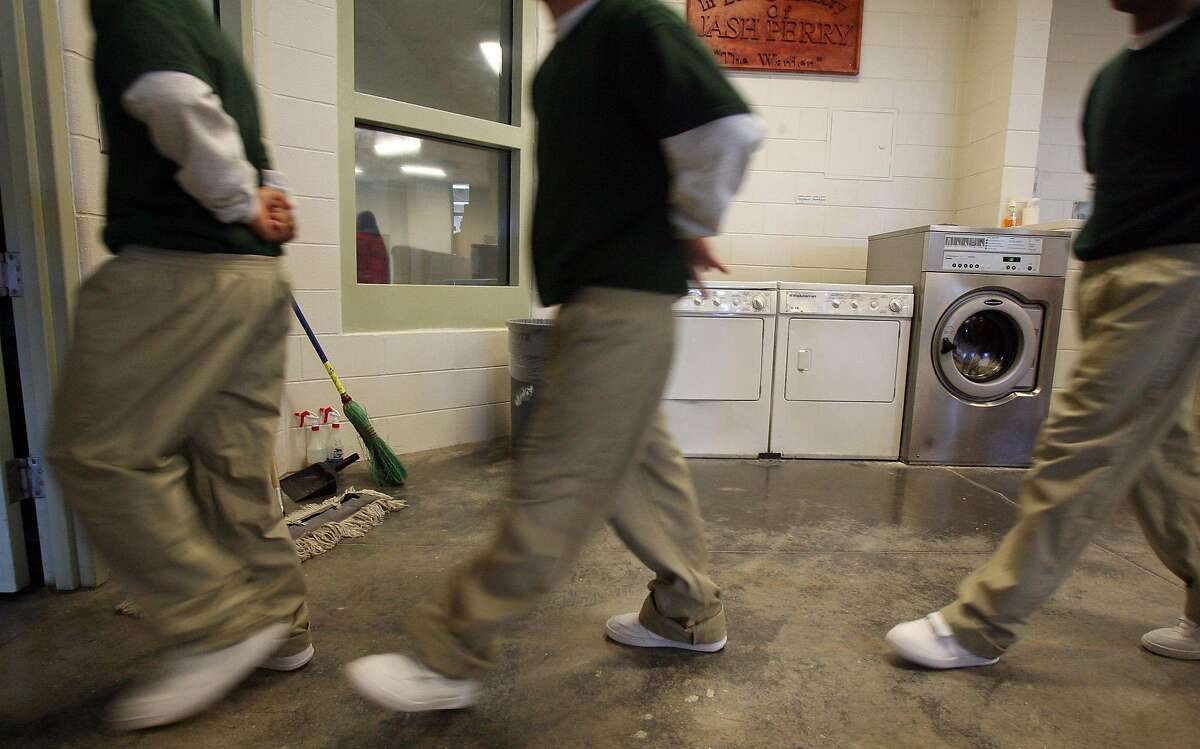 Juvenile offenders walk in line on their way to class at the Texas Youth Commission's McLennan County State Juvenile Correctional Facility in Mart, Texas near Waco. The jail is an intake facility where youthful offenders are brought into the system and it is determined what kind of rehablitation or treatment they will receive during the rest of their sentence. JOHN DAVENPORT / STAFF