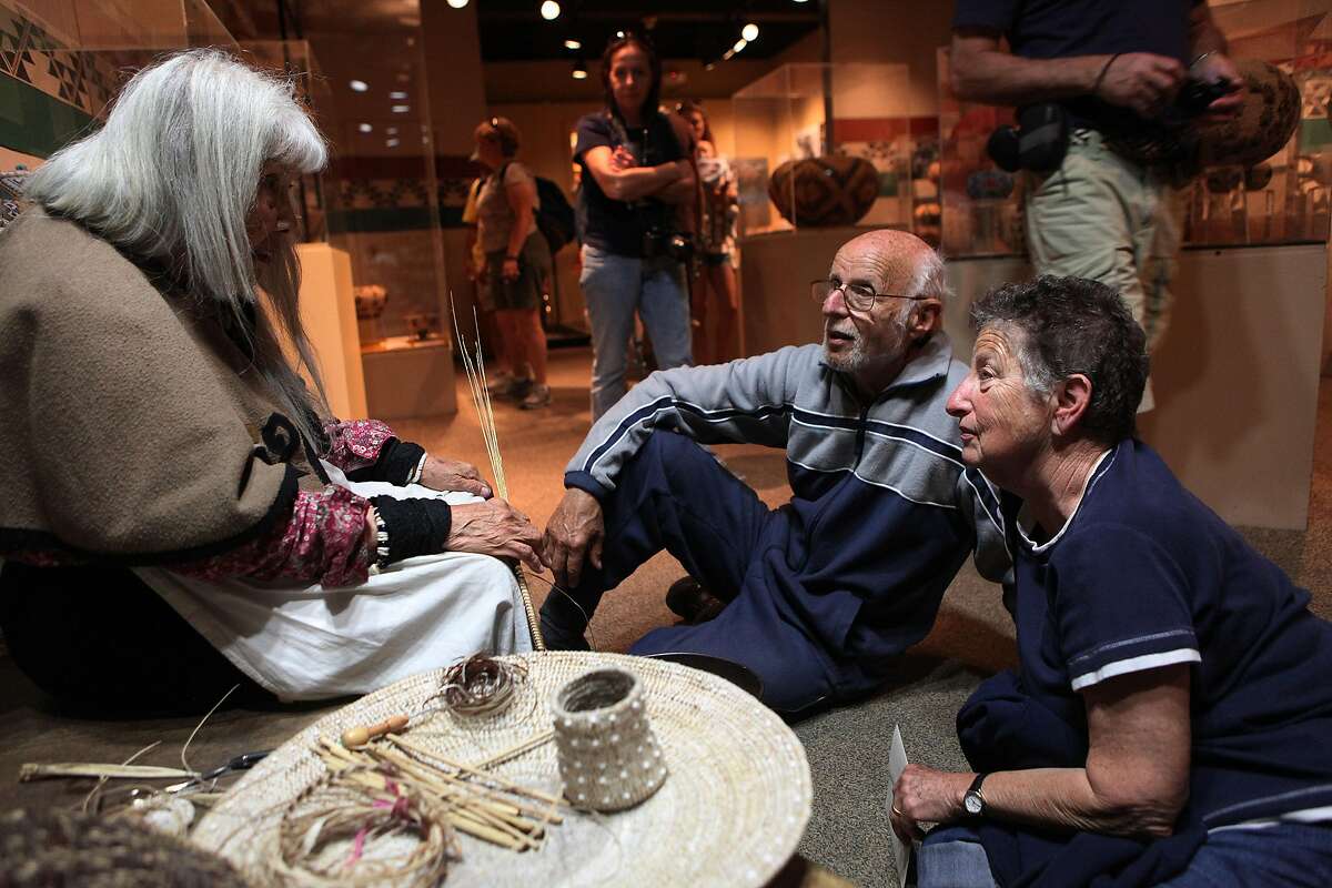 Melvin Mann and his wife Esther Mann (right) listen to Julia Parker as she weaves her basket at the Yosemite museum in Yosemite Valley, Calif., on Wednesday, May 29, 2013. Parker moved to Yosemite at the age of 17 and quickly began learning the craft of basket weaving from her husband�s grandmother and premier basket weaver, Lucy Telles.