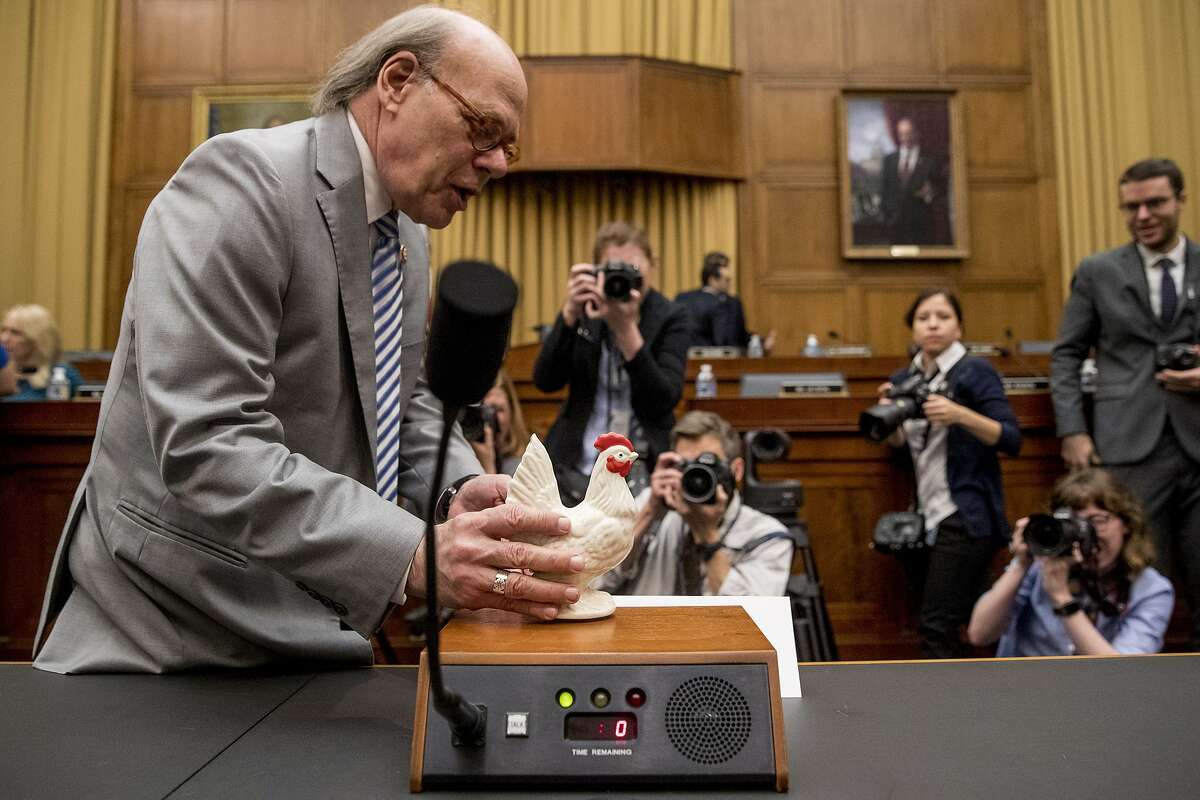 Rep. Steve Cohen, D-Tenn., left, places a prop chicken on the witness desk for Attorney General William Barr after he does not appear before a House Judiciary Committee hearing on Capitol Hill in Washington, Thursday, May 2, 2019. (AP Photo/Andrew Harnik)