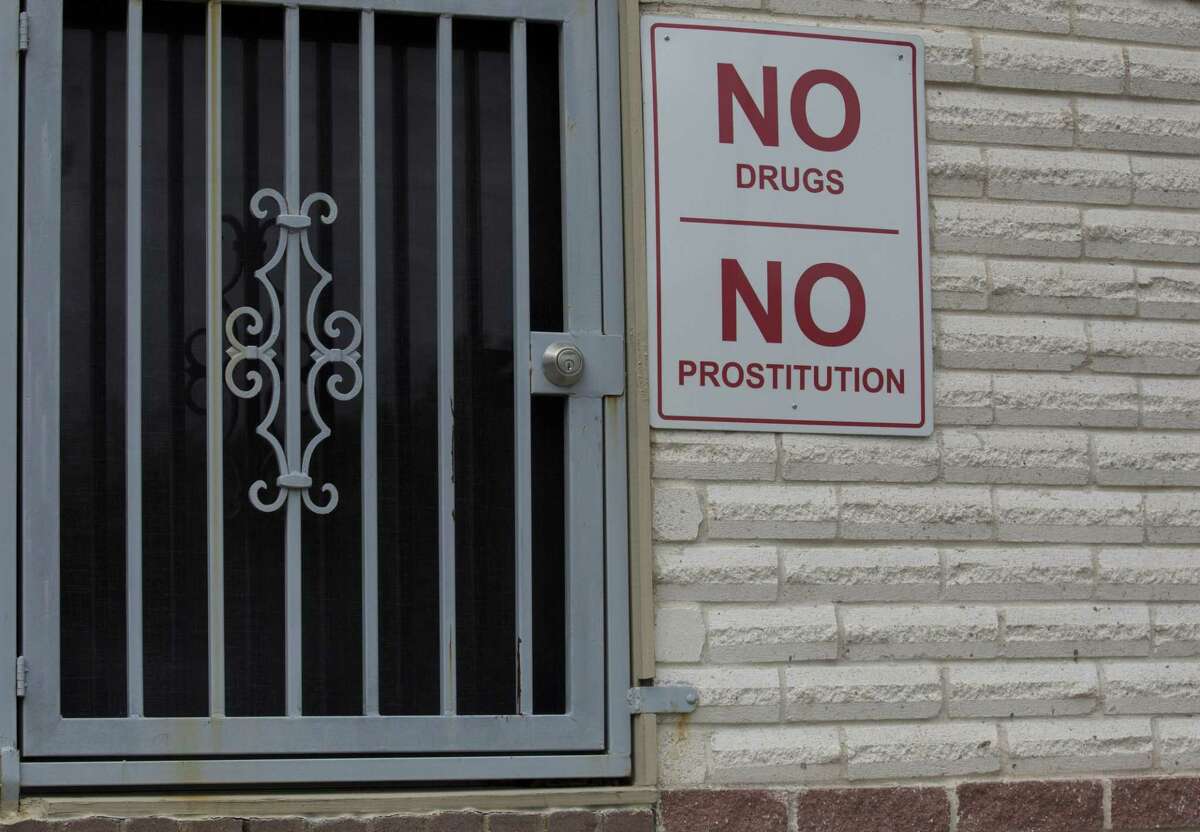 A sign warning against drugs and prostitution is posted at a motel in southwest Houston near the Bissonnet Track, a notorious hub for the sex trade.