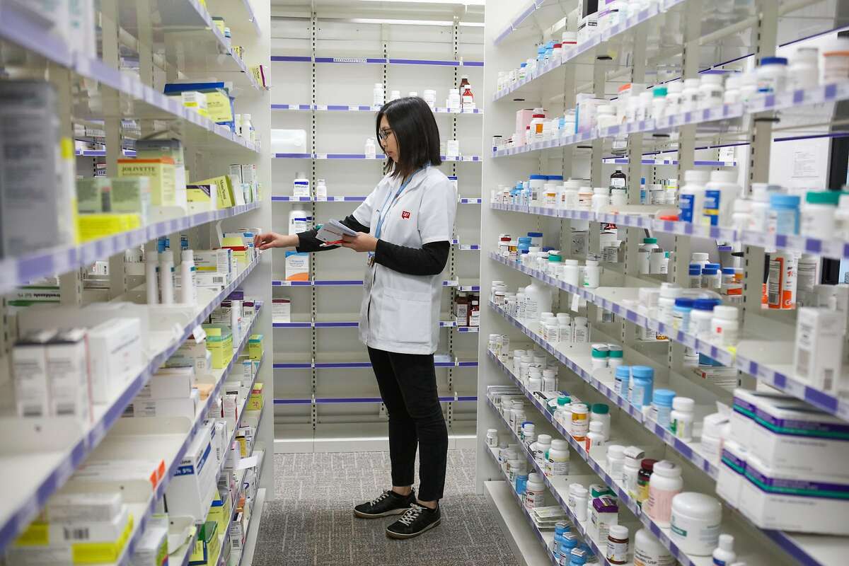 Pharmacist, Lisa Fung, of Walgreens Pharmacy, looks for the correct medicine to fill a prescription at Walgreens Pharmacy, in San Francisco, California on Friday, October 30, 2015.
