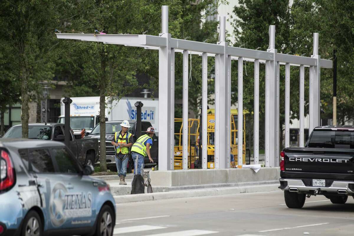 Construction workers erect a bus rapid transit station on Post Oak on April 30. Metropolitan Transit Authority officials are making a huge push toward bus rapid transit as part of a $7.5 billion transit plan.