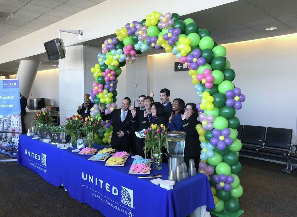 Balloons, flowers and other goodies along with some very happy flight attendants at United's inaugural SFO-Amsterdam flight celebration