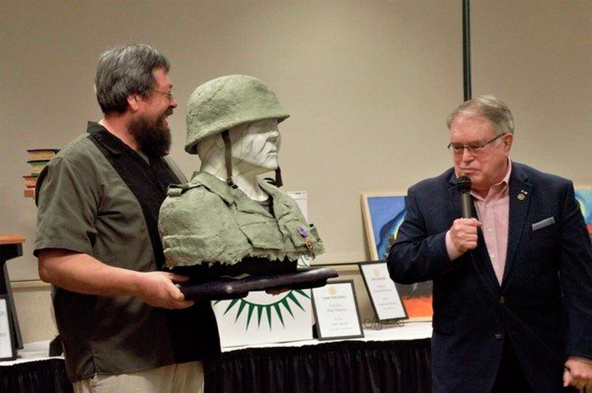 John Martinez (left) and Fred Honerkamp (right) explain that the paper mache bust was inspired by Honerkamp's service in the Vietnam War 50 years ago. (Ashley Schafer/ashley.schafer@hearstnp.com)