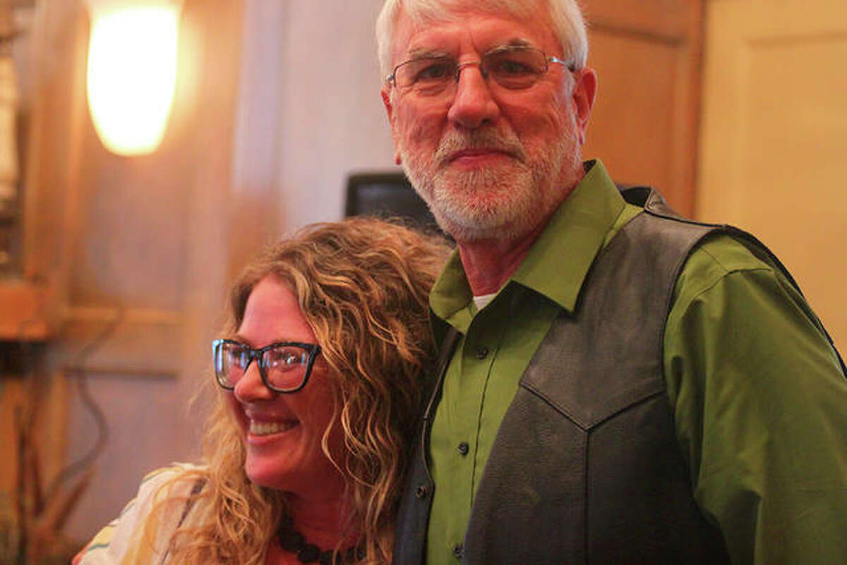 Wes Hendricker (right) hugs Heather Wardlow, who nominated him for a Kiwanis Lay Person of the Year award.