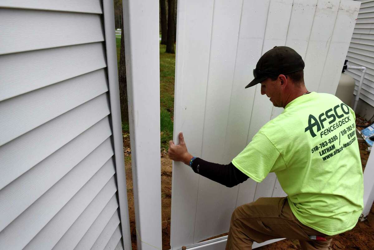 James Huntley with AFSCO Fence & Deck, installs a vinyl fence on Tuesday, April 30, 2019, in Wilton, N.Y. (Will Waldron/Times Union)