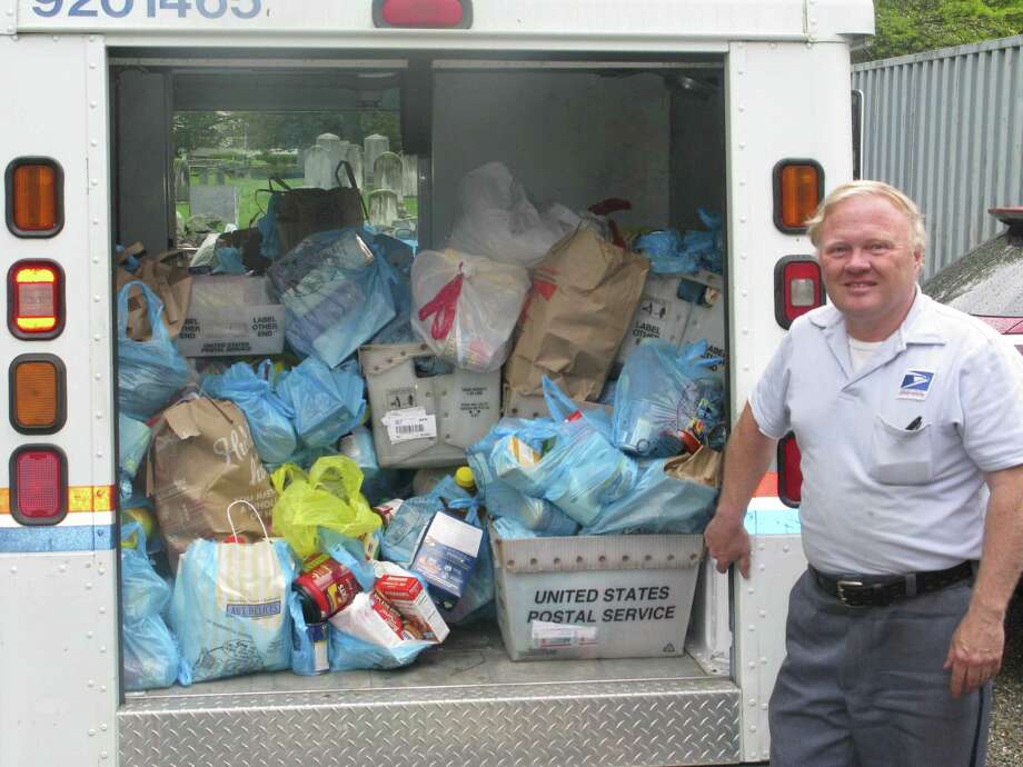 The annual Stamp Out Hunger food drive will benefit Neighbor to Neighbor. In 2014, letter carrier Glen Purdy collected 160 bags of donated food along his route. Photo: Contributed Photo / Contributed Photo / Greenwich Citizen