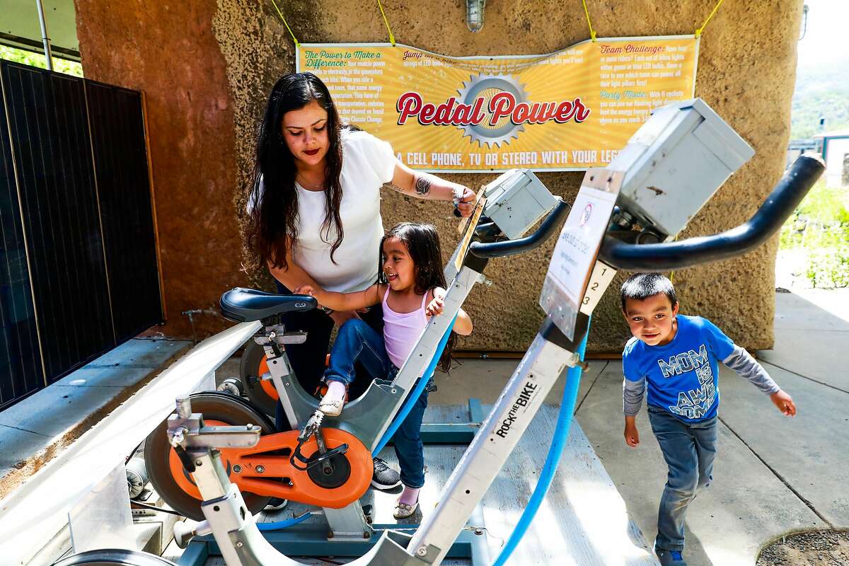 (l-r) Mayra Villafania and her children Nancy, 4, and Damian, 7, check out the bicycles at the Solar Living Center in Hopland, California, on Wednesday, May 1, 2019. Flow Kana recently bought the 12-acre property and will invest money into it to make it a visitors center.