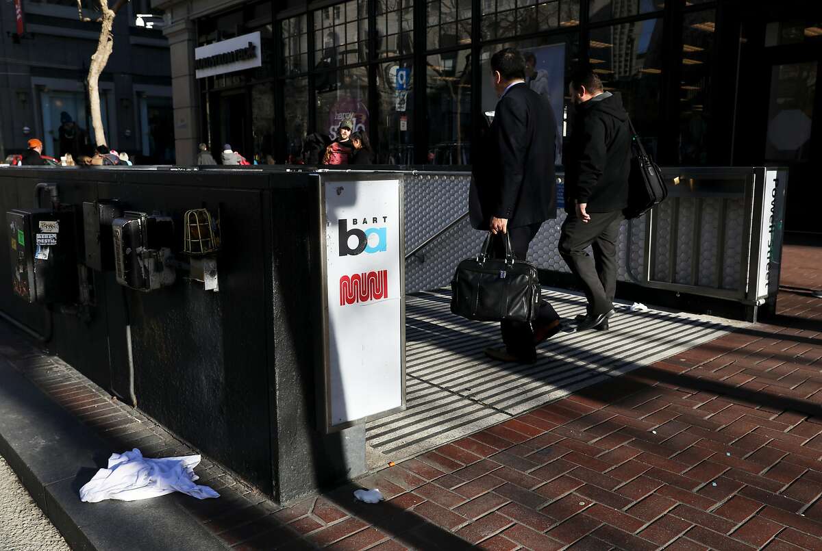 Riders enter the BART Powell Street Station at Market and 5th where discarded clothing and trash lay nearby in San Francisco, Calif., on Tuesday, January 22, 2019.