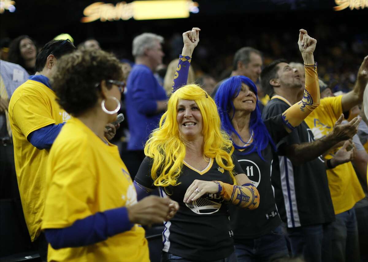 Julie Lane and Amy Fowler wear Warrior color wigs for the Golden State Warriors win over Houston Rockets in game 2 on Tuesday, April 30, 2019 in Oakland, CA.