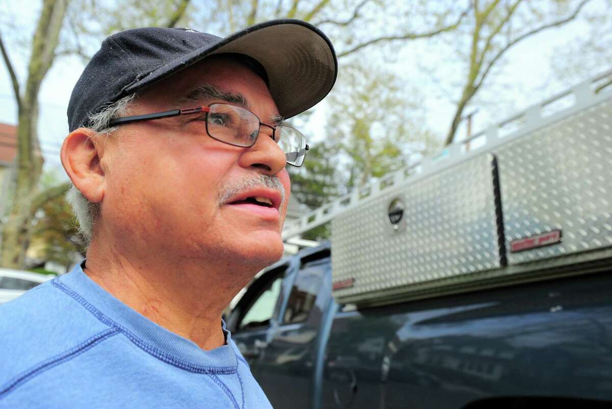 Angel Maldonado watches as volunteers from St. Paul's Episcopal Church in Fairfield work to spruce up his home during the 32nd annual HomeFront Day in Bridgeport, Conn., on Saturday May 4, 2019. HomeFront's campaign is to make life-changing repairs to the homes of 60 older adults on fixed incomes, single-parent households, persons with disabilities and families in transitional crisis due to illness or job loss.