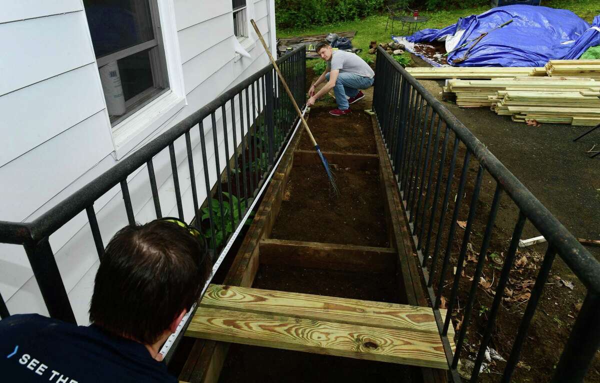 Factset employees including Craig Nesbitt and DEvin Wallace make repairs and renovations on the Keystone Elmcrest Terrace Group Home.