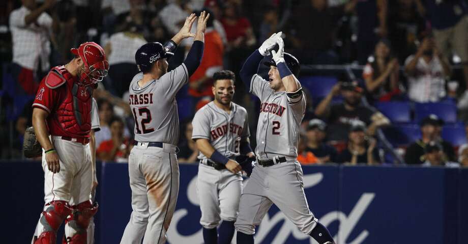 Alex Bregman of the Houston Astros, right, is congratulated by teammate Max Stassi, who returns home after hitting a shot in the eighth inning of a baseball game against the Los Angeles Angels, in Monterrey, in Mexico, Saturday, May 4, 2019. (Photo AP / Rebecca Blackwell) Photo: Rebecca Blackwell / Associated Press