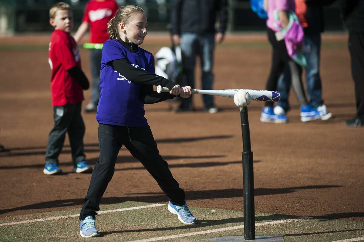 Addison Hills, 7, swings a bat during the annual Pitch, Hit and Run event on Saturday, May 4, 2019 at Dow Diamond. (Katy Kildee/kkildee@mdn.net)