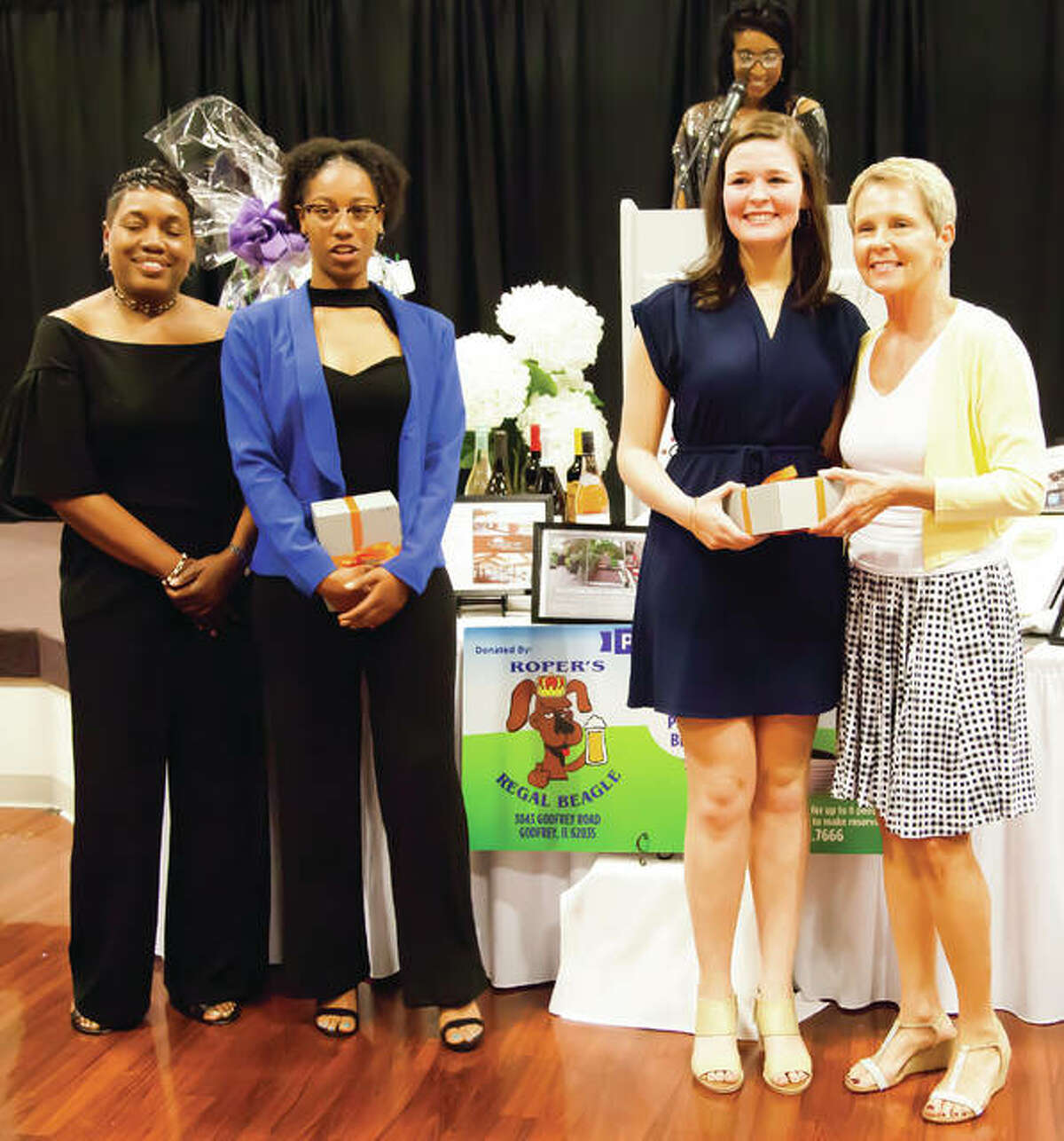 The 2019 Josephine Marley Beckwith Future Leader Scholars, Ashlynn Green and Regan Windau, were also honored during the YWCA’s 29h Annual Women of Distinction Award Dinner held at the Lewis and Clark Community College Campus. Pictured (left to right) are YWCA Board Member Lisa Brown, Alton High School Senior Ashlynn Green, Edwardsville High School Senior Regan Windau, and YWCA Board Member Theresa Franklin. Raynah Ray (background) was the EMCEE for Thursday’s event.
