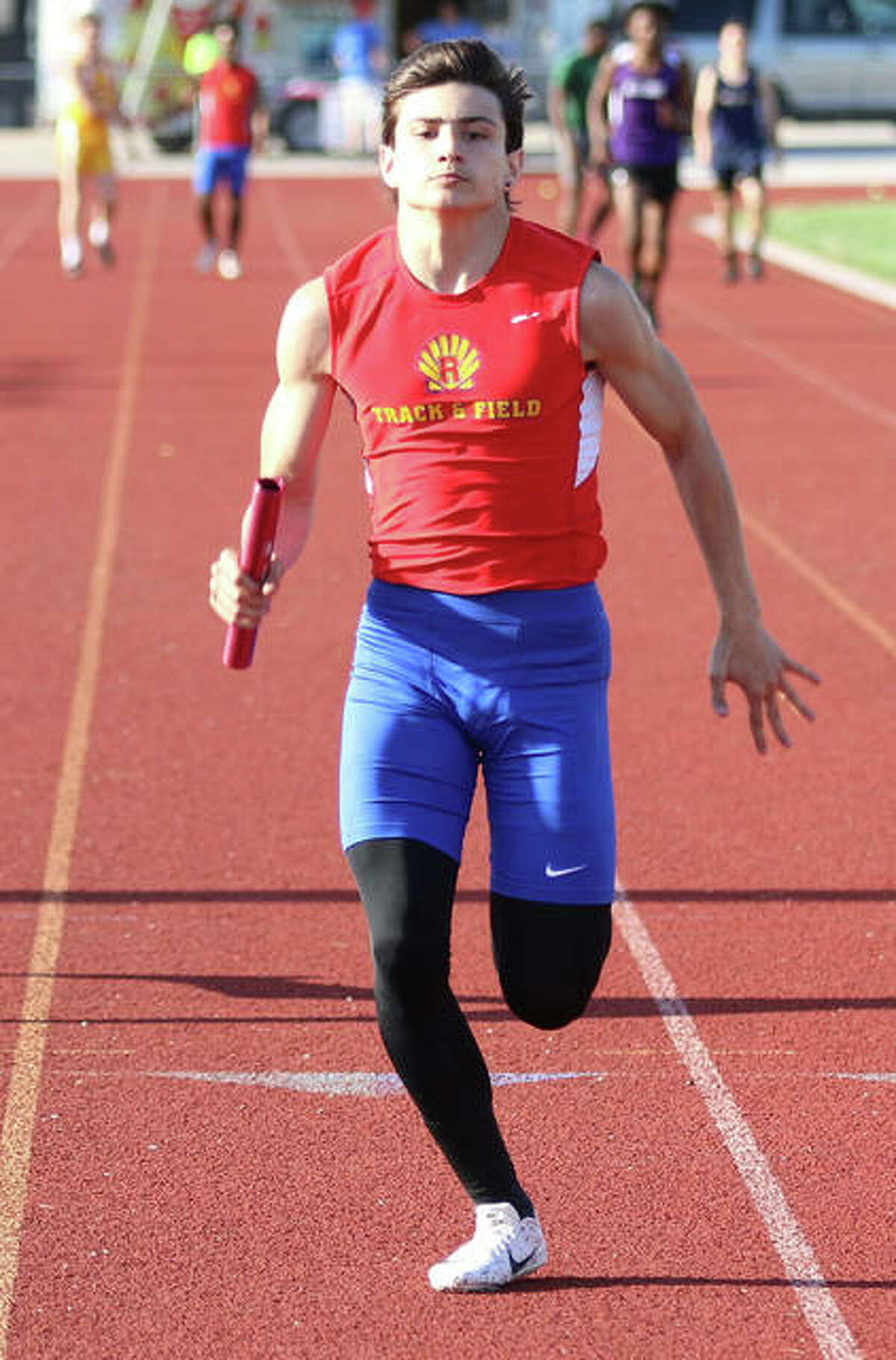 Roxana’s Dylan Murray brings home the 4x100 relay for the Shells at the Madison County Meet on April 22 in Roxana. The Shells sophomore took on a large-schools field in the 100 meters on Saturday at the Collinsville Invite and finished sixth in 11.37 seconds.